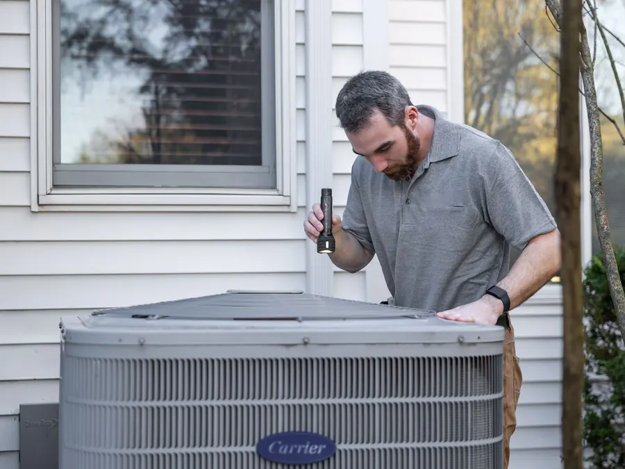 Outdoor air conditioning equipment being inspected
